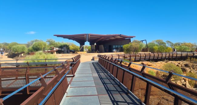 View of the Kalbarri Skywalk Cafe taken from the walkway, with clear blue skies and surrounding native bushland. Kalbarri Tours available