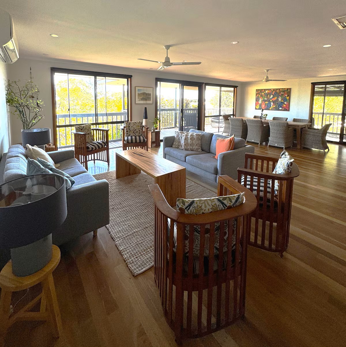 A collage of scenic views from a holiday home in Kalbarri, featuring ocean vistas, rugged coastal landscapes, and a modern outdoor deck with seating. The central text reads "Relax, Unwind, Enjoy," highlighting the peaceful and serene atmosphere of the accommodation.